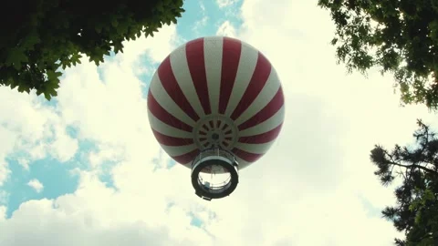 A tourist balloon rises into the sky, creating a feeling of lightness, freedom a 動画素材 310515554