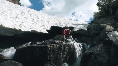 Tourist bathing in a mountain stream Stock Footage 83697696