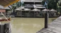 Tourist boat goes under a bridge in Pattaya floating market. HD Footage