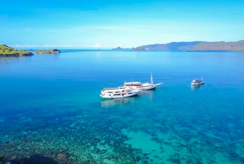 Tourist boats at Gili lawa island with a clear blue sea, Flores, Indonesia . Stock Photos