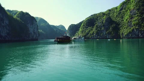 Tourist Boats Navigating Limestone Cliffs in Halong Bay Vietnam Stock Footage 340017315
