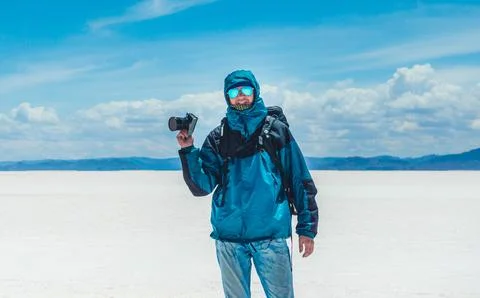 Tourist with camera in sunshine Salar de Uyuni Stock Photos