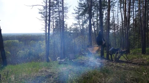Tourist camp with a bonfire in the forest Stock Footage 74610639