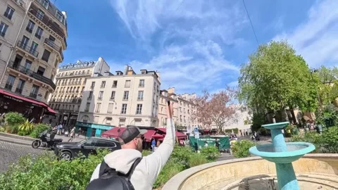 Tourist Capturing Bullet Time Video in Paris Square with Cobblestone Streets Stock Footage 328988916