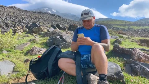 Tourist checking phone front view at a mountain rest stop on Mount Ararat Stock Footage 343804790