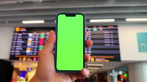 Tourist checking schedule table at the airport terminal and using phone Stock Footage 280693036