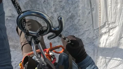 Tourist climber descends down a rope on a trigger device - the "Eight" Stock-Footage 208438565