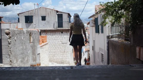 Tourist in colorful clothes walking down the stairs in Split, Croatia. Stock Footage 98042425