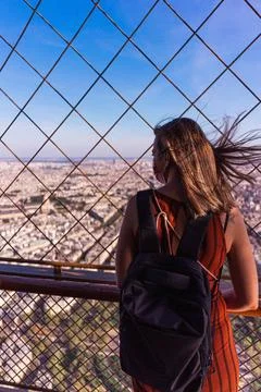 Tourist contemplating Paris from the Eiffel tower Tourist contemplating th... Stock Photos