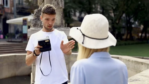 Tourist Couple. Man With Camera Taking Photos Of Woman In Street. Smiling Young  Stock Footage 123660193