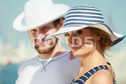 Tourist couple in marina against yachts in port Stock Photos