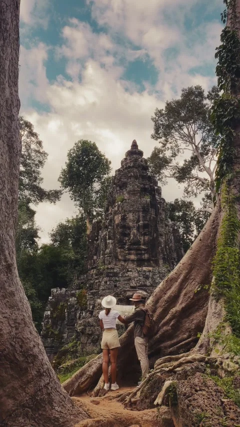 Tourist Couple Reading Map At Victory Gate Bayon Temple Angkor Thom Cambodia Stock Footage 345341185