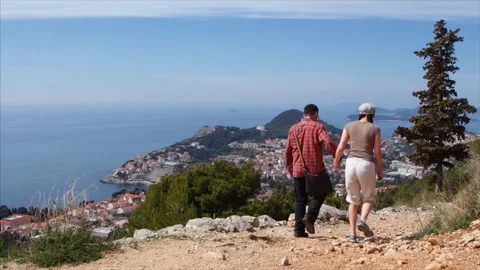 Tourist couple walk down the path on Mount Srd in Dubrovnik 動画素材 74024432