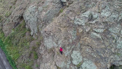 A tourist crawls up the mountain Stock Footage 293546422