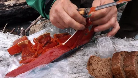The tourist is cutting the fish  Stock Footage 84006277