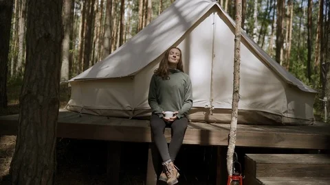 Tourist drinking tea from cup in the forest camping Stock Footage 112163822