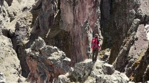 Tourist on the edge of a cliff Stock Footage 63364750