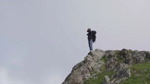 Tourist on the edge of a cliff Stock Footage 138125490