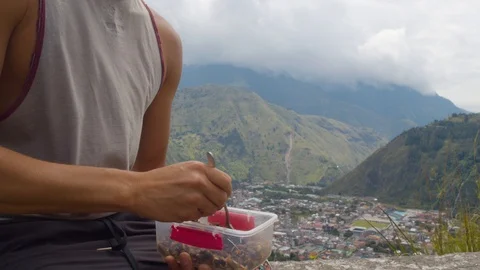 Tourist enjoying his meal while watching the landscape in ecuador Stock Footage 115349341