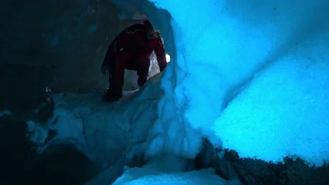 A tourist enters an ice cave covered with snow. Stock Footage 234271753