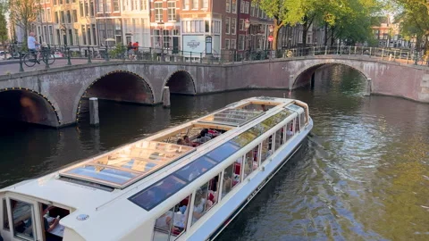 Tourist excursion boat floating at the Amsterdam canals Stock Footage 293438524