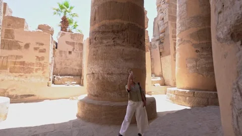 Tourist exploring karnak temple columns montage 스톡 동영상 310953877