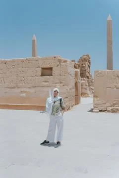 Tourist exploring karnak temple complex with obelisks and ancient walls in luxor Stock Photos