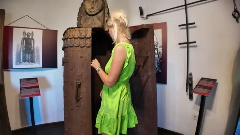 Tourist exploring medieval torture device iron maiden in museum exhibition Stock Footage 319709828