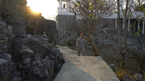 Tourist Exploring Temple on Top of Hill and Looking at Beautiful View of Island Stock Footage 126577847