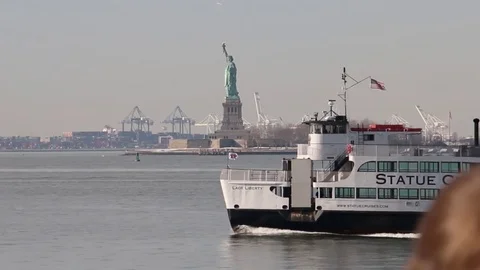 Tourist ferry passing in front of the Statue of Liberty Stock Footage 81007663