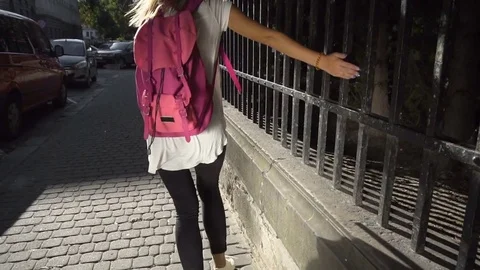 Tourist Girl Running down the Sidewalk Stock Footage