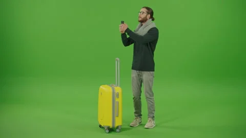 Tourist in Glasses Scarf Passing through with Trolley Bag Looking Around Stock Footage 220471853