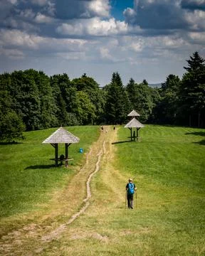 A tourist in green scenery, walking down a path from Swiety Krzyz, Poland. Stock Photos