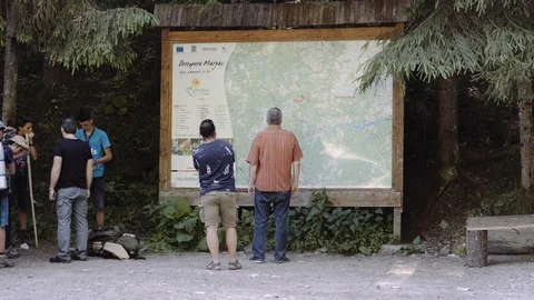 Tourist guide looking over map Stock Footage 111806722