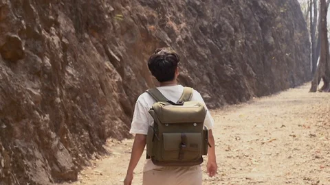 Tourist guy walking in hellfire pass rock mountain to discover Thailand Stock Footage 103042252