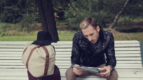 A tourist in a hat with a suitcase and a map Stock-Footage 80492972
