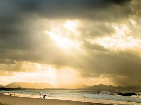 Tourist having fun in beach during sunset Stock Footage