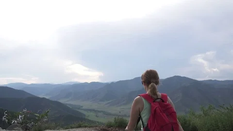 Tourist on the high mountain enjoying the view. girl winner happily raises his Stock Footage 77049853