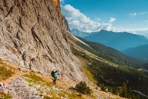 Tourist hiking in mountains Sella Ronda Stock Photos