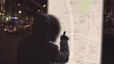 Tourist in jacket hand points to large Moscow map planning the way to sights 스톡 동영상 72632829