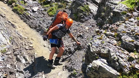Tourist with a large backpack goes down a mountain trail Stock-Footage 158614361