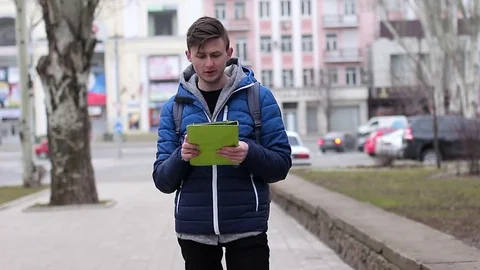 A tourist looking for an address. He using a tablet PC Video stock 73462209