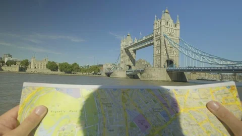 Tourist looking a map with tower bridge behind POV Stock Footage 95292099