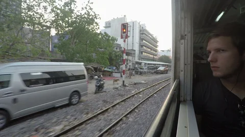 Tourist Looking Out of Train Window Driving Through Suburbs of Bangkok Stock Footage 127601949