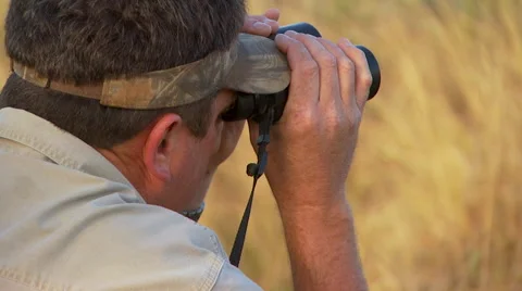 Tourist looking through binoculars at ranch Stock Footage 54591229