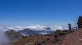 Tourist makes photo of heavenly clouds upcoming from valley to mountain peak Photo