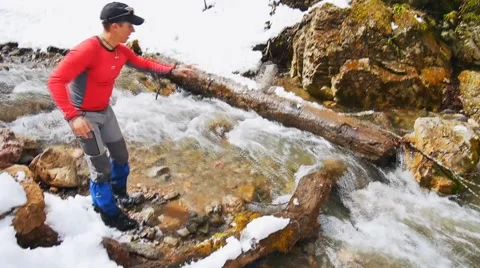 Tourist makes the transition through the river of stones Video stock 50769995