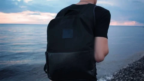 Tourist Man with Backpack Walking on Beach by Sunset Sea Vidéo 79037707