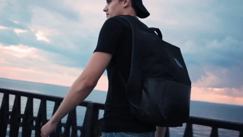 Tourist Man with Backpack Walking on Beach by Sunset Sea 스톡 동영상 79037739