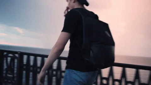 Tourist Man with Backpack Walking on Beach by Sunset Sea 스톡 동영상 79037763